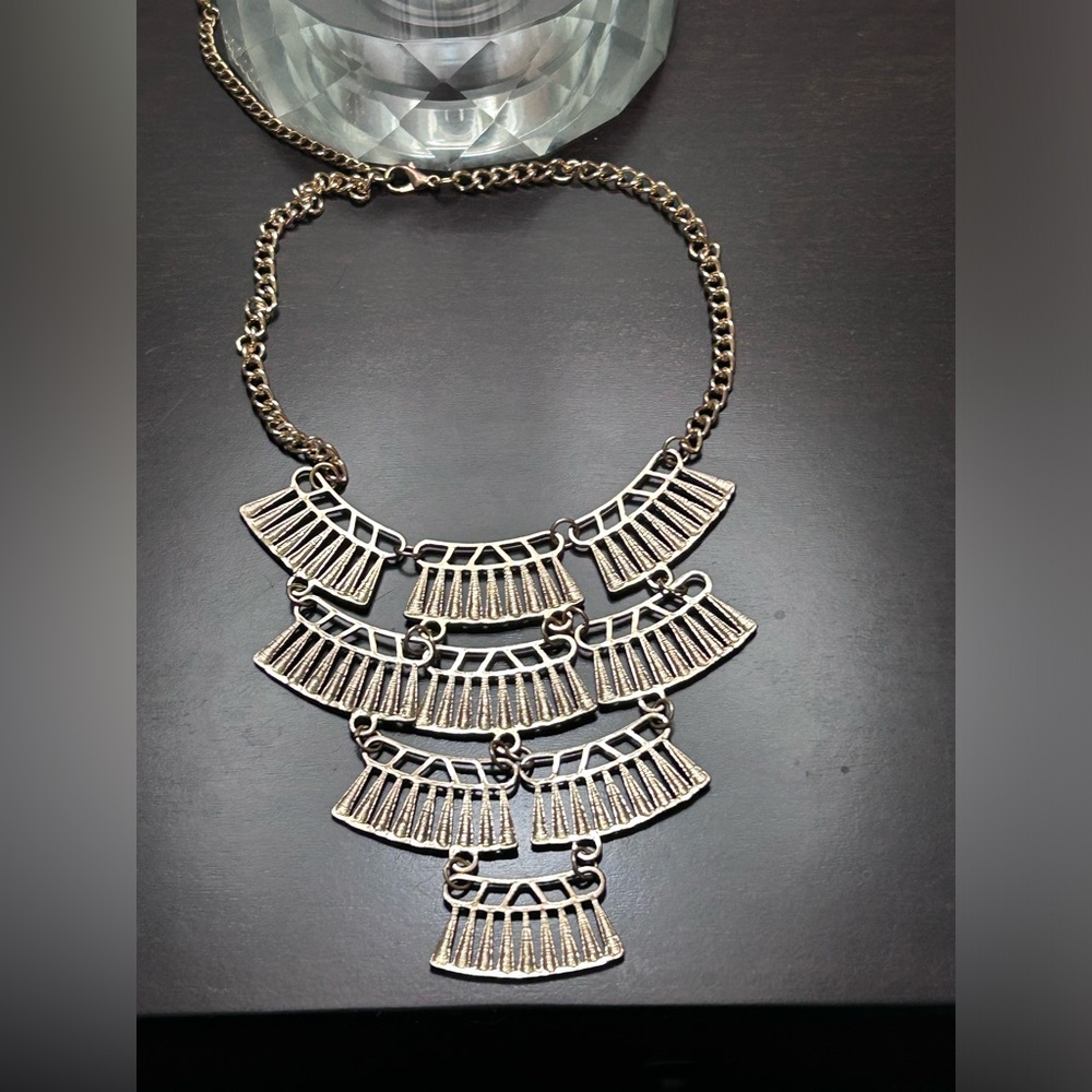 Gold coloured necklace.